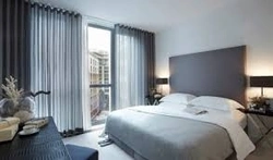 Gray curtains in the bedroom interior