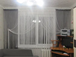 Thread curtains in the living room interior