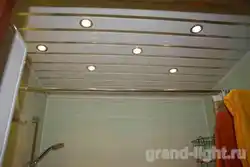 Spotlight in a plastic ceiling in the bathroom photo