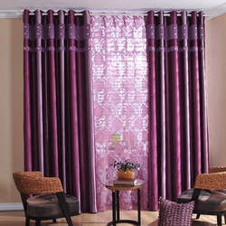 Purple curtains in the living room interior