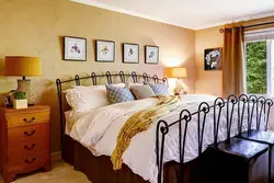 Paintings on the wall in the bedroom above the bed photo