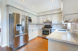 Kitchen with gold refrigerator photo