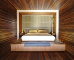 Wooden bed in the bedroom interior photo