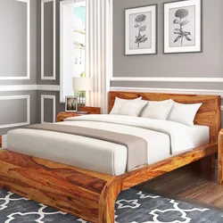 Wooden bed in the bedroom interior photo