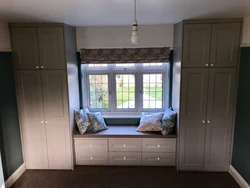 Bedroom design with wardrobe around window