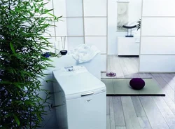 Vertical washing machine in the bathroom interior