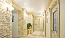 Decorative stone in the interior with hallway wallpaper