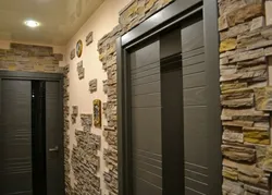Decorative stone in the interior with hallway wallpaper