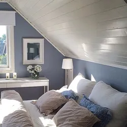 Bedroom in the attic with a sloping ceiling photo