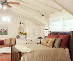 Bedroom in the attic with a sloping ceiling photo