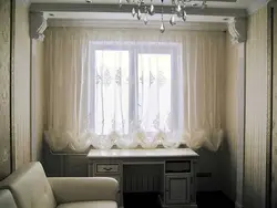 Curtains up to the windowsill in the living room interior