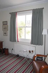 Curtains up to the windowsill in the living room interior