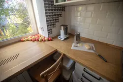 Countertop together with a window sill in the kitchen photo