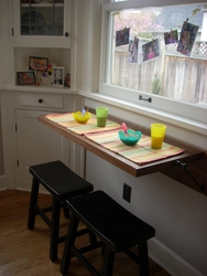 Countertop together with a window sill in the kitchen photo