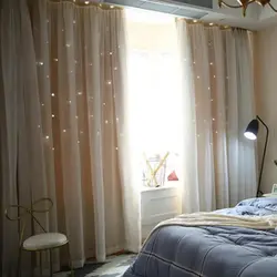 Curtains in the interior of a small bedroom photo