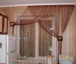 Thread curtains for the kitchen in the interior real photos