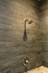 Wood-look porcelain tiles on the wall in the bathroom photo