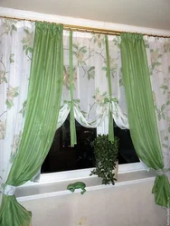 Light green curtains in the kitchen interior