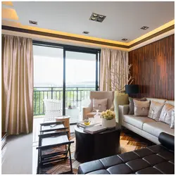 Photo of curtains in the living room with brown furniture