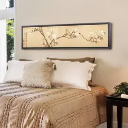 What kind of paintings are hung in the bedroom above the bed photo