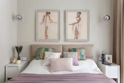 What kind of paintings are hung in the bedroom above the bed photo