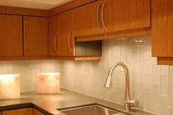 Laying tiles on a kitchen backsplash photo