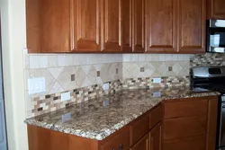 Laying tiles on a kitchen backsplash photo