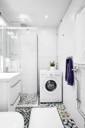 Small bathroom with shower and washing machine photo