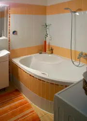 Asymmetrical bathtub in the bathroom interior