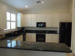 Beige kitchen design with black countertop