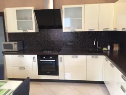 Beige kitchen design with black countertop