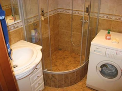 Small bath design with shower and washing machine photo