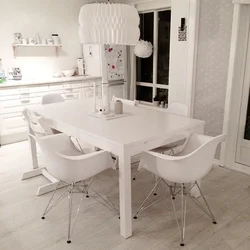 White chairs and table in the kitchen interior