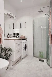 Showers and washing machines in a small bathroom photo