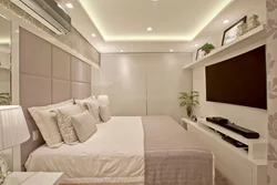 Wall design in the bedroom opposite the bed with TV