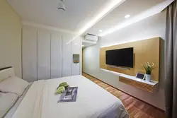 Wall design in the bedroom opposite the bed with TV
