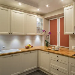 Kitchen with wooden countertop in beige interior
