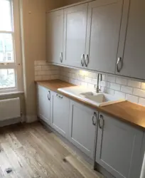 Kitchen with wooden countertop in beige interior