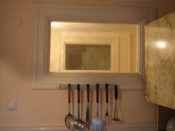 Khrushchev kitchen design with a window to the bathroom