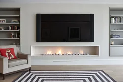 Bio-fireplace in the interior of the living room with TV
