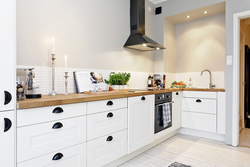Photo of a kitchen without upper cabinets with an apron