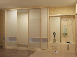 Built-in wardrobe in the hallway in light colors photo