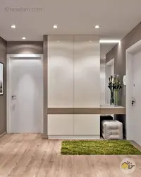 Built-in wardrobe in the hallway in light colors photo