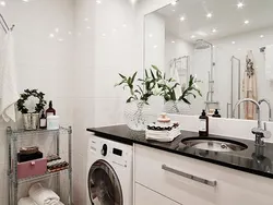 Photo of a bathroom countertop under the sink and washing machine