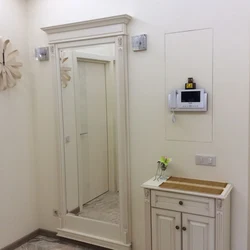 Hide the electrical panel in the hallway photo