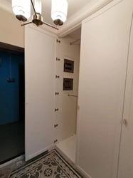 Hide the electrical panel in the hallway photo