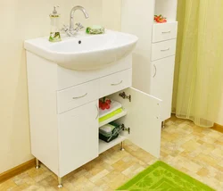 Washbasin in the bathroom with cabinet photo