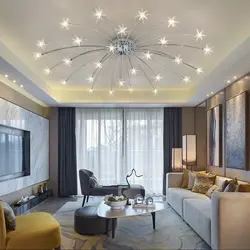 Suspended ceiling with spotlights and chandelier in the living room photo