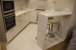 Kitchen design in a modern style in light colors with bar