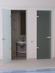 Doors to the bathroom and toilet in the interior photo